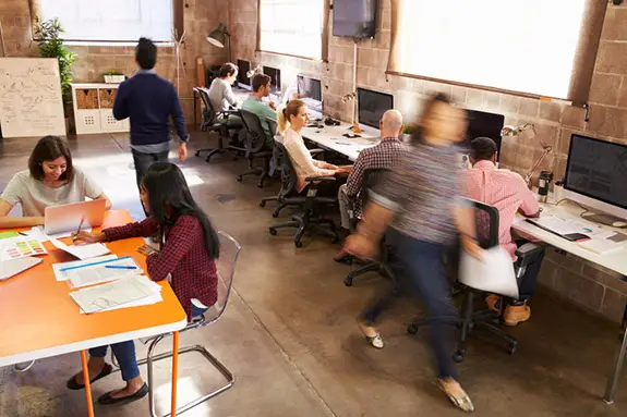 People rushing around a busy office