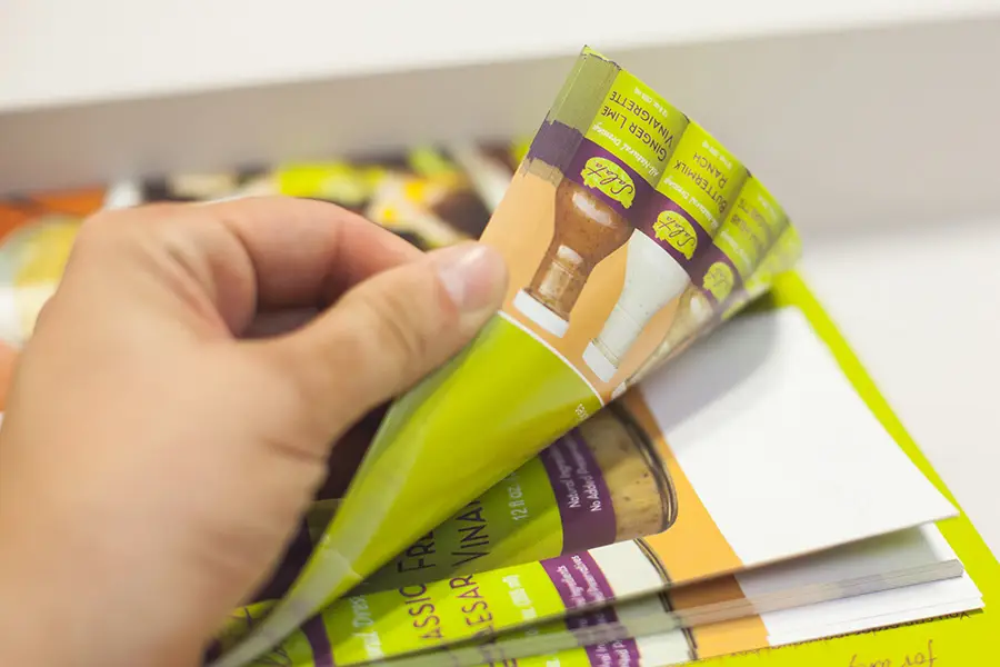 A man flipping through a stack of prints