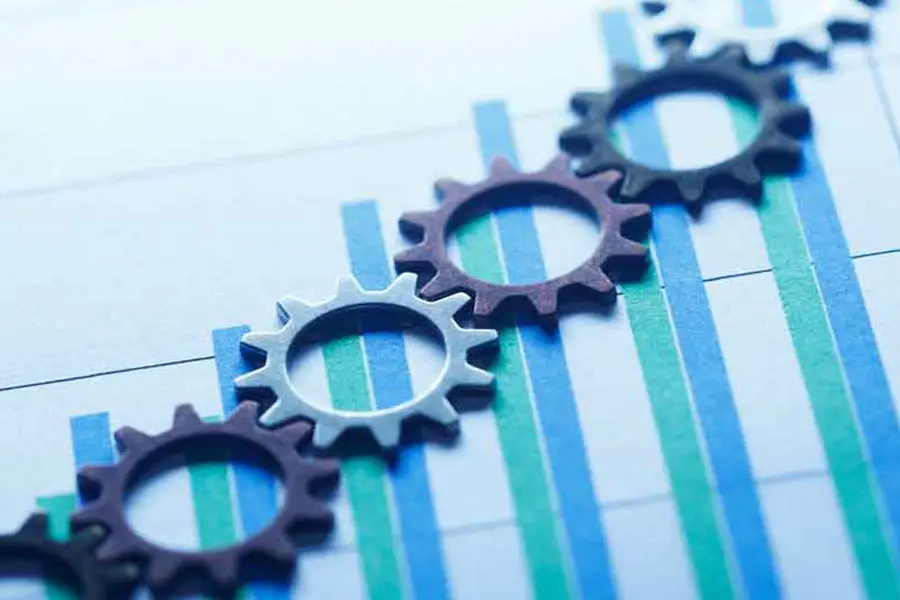 A series of gears on top of a printed graph