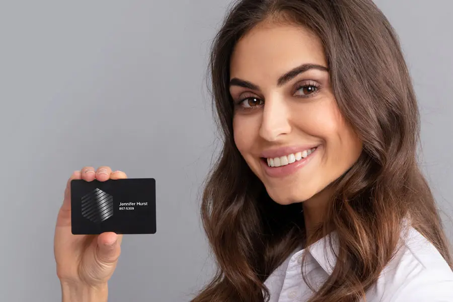 A woman holding a business card with UV printing