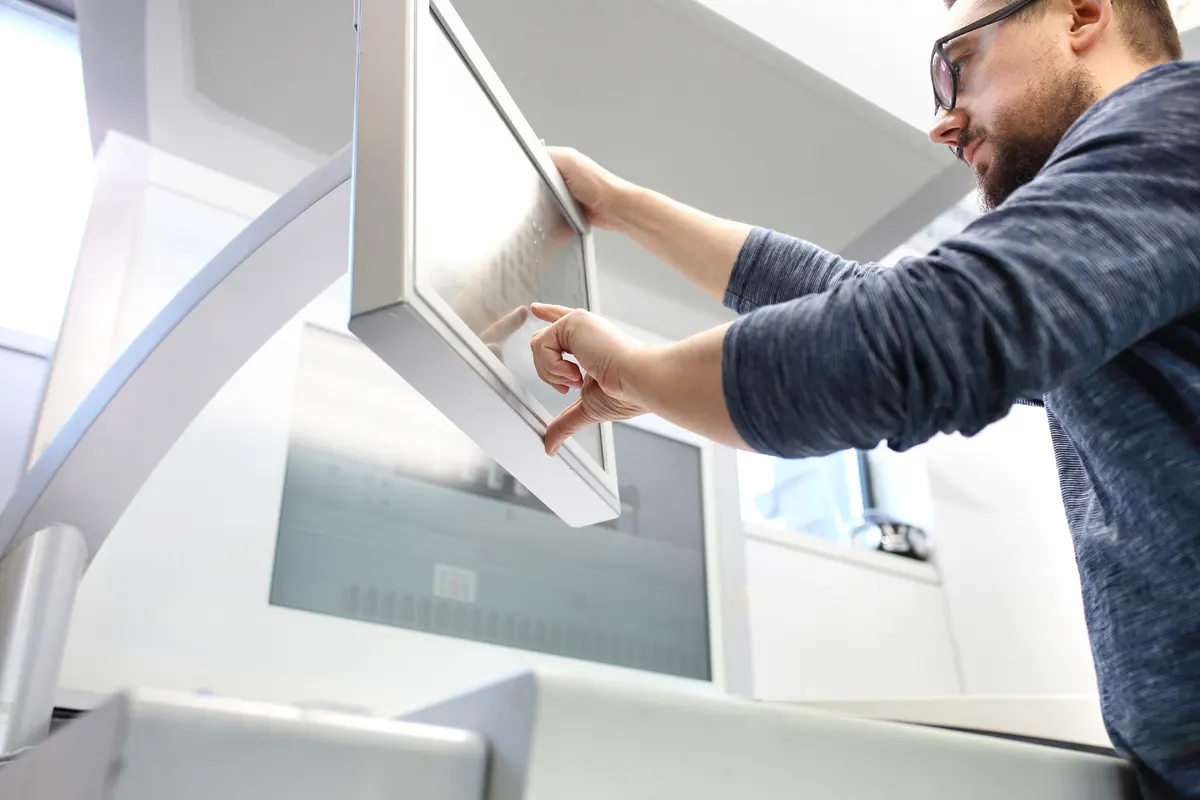 A managed services staff member operating a printer